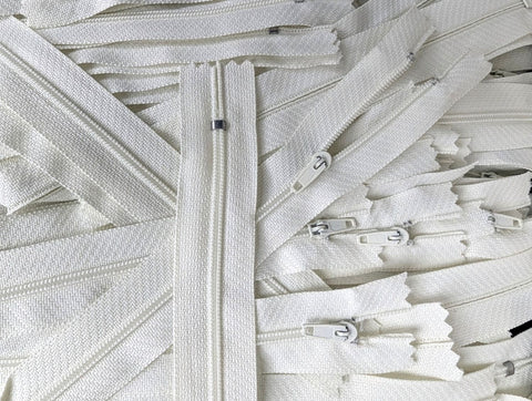Closed end zips. 18cm long, no.3 size nylon centre fastening and bridal white/ivory polyester fabric.