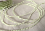 Micro pearl bead string, 1.6mm width, pale lime green.