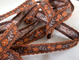 16mm wide vintage brown, orange & grey cotton braid trim with a floral woven jacquard.