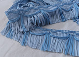 Two tone blue fringing with a silky sheen. 50mm width.