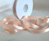 15mm width peach double face satin ribbon. sold by the metre or big discounts for longer lengths and full rolls. Ribbonmoon sewing supplies uk