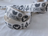 Berisfords premium quality pale beige rustic cotton look polyester taffeta ribbon with a graphite Christmas motif print. 25mm wide. Cut to length at Ribbonmoon Haberdashery Shop.