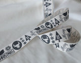 Berisfords premium quality pale beige rustic cotton look polyester taffeta ribbon with a graphite Christmas motif print. 25mm wide. Cut to length at Ribbonmoon Haberdashery Shop.