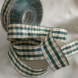 1"-inch width green and cream tartan plaid ribbon with thin gold metallic stripe. Wire edge.