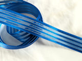 25mm width royal blue satin, sheer and thin metallic gold striped ribbon. Buy per metre, cut to length. Ribbonmoon huge online Berisfords Ribbons range.