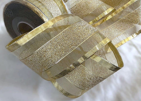 Gold mesh ribbon with solid and tinsel stripes. Sold by the metre with quantity discounts on 10 metre lengths. Buy ribbons online at ribbonmoon