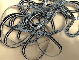 Black and grey strung sequin string, 6mm wide.