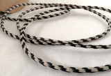 2mm wide black and beige rustic twine. Made in the UK by Berisfords Ribbons