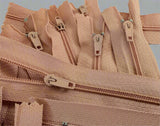 Closed end zips. 18cm long, no.3 size nylon centre fastening and dusky peach polyester fabric.