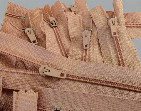 Closed end zips. 18cm long, no.3 size nylon centre fastening and dusky peach polyester fabric.