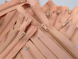Closed end zips. 18cm long, no.3 size nylon centre fastening and dusky peach  polyester fabric.