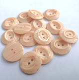 23mm peach satin sheen polyester 2 Hole Button with pearlised shimmery elements and an oval centre.
