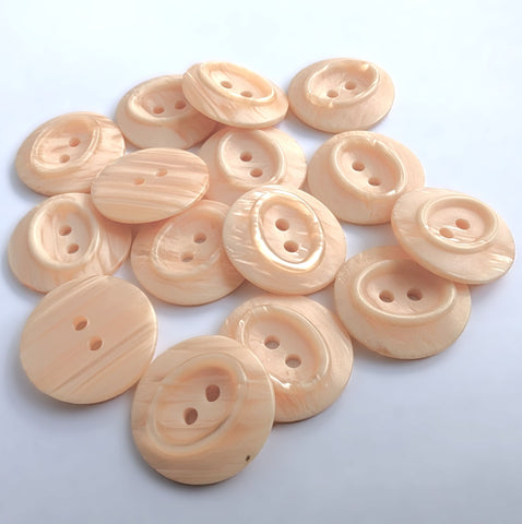 23mm peach satin sheen polyester 2 Hole Button with pearlised shimmery elements and an oval centre.