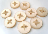 11mm pearlised polyester 4 Hole button with an indented matte star/flower.