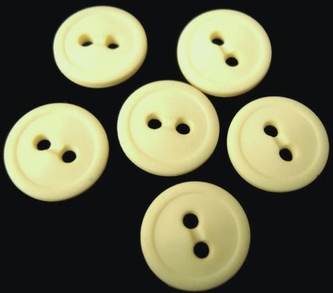 13mm primrose‑mist matte nylon 2 hole button with smooth rounded profile.