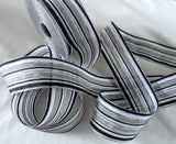 black, white, grey and metallic silver solid and sheer striped ribbon, 4cm in width.