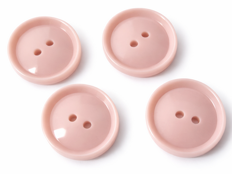 19mm flesh‑pink glossy polyester 2 hole button with smooth rounded face and raised rim.