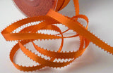 Orange satin ribbon with picot edge 