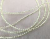 Micro pearl bead string, 1.6mm width, pale lime green.