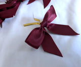 30 maroon satin ribbon bows with a centre wire for attachment. 7cm x 6cm . Clearance sale, less than 9p each. Ribbonmoon UK craft & sewing online.