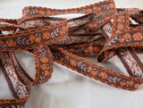 16mm wide vintage brown, orange & grey cotton braid trim with a floral woven jacquard.