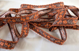 16mm wide vintage brown, orange & grey cotton braid trim with a floral woven jacquard.