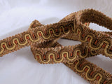 Close‑up of brown and gold vintage braid showing deep woven structure and matte finish.