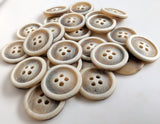 20.5mm width four hole button with a bone sheen and raised ringed rim. Frosted toffee brown with a grey element.