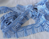 Two tone blue fringing with a silky sheen. 50mm width.