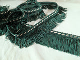 50mm Lampshade and soft furnishing trimming. Dark green fringe trim with a cream pearl in the corded braid. Ribbonmoon trims online shop.