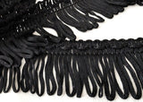 Black 35mm looped fringe on a decorative braid.