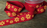 Red cotton tape ribbon with an orange daisy print