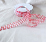 Roll of red and white 15mm super sheer gingham ribbon with crisp check design.