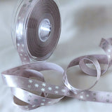 Berisfords 15mm silver grey satin ribbon with a metallic snowflake festive print