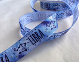 Berisfords 15mm Libra zodiac sign printed taffeta ribbon in blue with constellation design