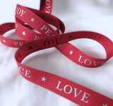 15mm red Berisfords taffeta ribbon with metallic stars and Joy Peace Love Noel lettering.