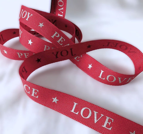 15mm red Berisfords taffeta ribbon with metallic stars and Joy Peace Love Noel lettering.