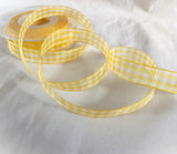 Roll of yellow and white 15mm super sheer gingham ribbon with crisp gingham check design.