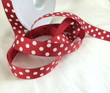 16mm width dusky red polyester grosgrain ribbon with ivory polka dots. Made by Berisfords Ribbons in the UK. Sold by the metre Ribbonmoon ribbons UK