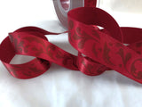 Deep red 25mm satin ribbon with a subtle baroque leafy print. Ribbonmoon online shop, buy rare unusual ribbons sold by the metre, cut to length.