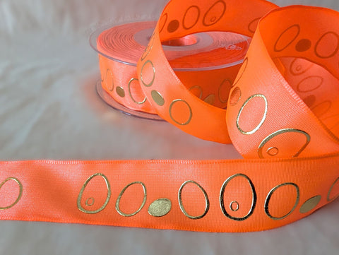 Full 20m reel of 25mm fluorescent orange wired taffeta ribbon with metallic gold‑embossed oval pattern.