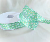 Berisfords daisy print satin ribbon in green, great for gift wrapping, wedding favours, and hair bows