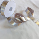 25mm wide silver grey printed satin ribbon. Metallic silver and gold geometric cross hatch design by Berisfords Ribbons K. Buy online per metre and cut to length. Ribbonmoon Haberdashery Shop.