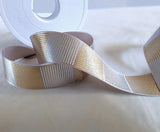 25mm wide silver grey printed satin ribbon. Metallic silver and gold geometric cross hatch design by Berisfords Ribbons K. Buy online per metre and cut to length. Ribbonmoon Haberdashery Shop.