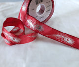 Red wire edge taffeta ribbon with a metallic silver feather print. 2.5cm wide, UK made by Berisfords Ribbons. Buy online & cut to length by the metre with discounts on 10 metres & full reels.