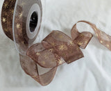Berisfords Ribbons Dark brown super sheer ribbon with a metallic gold Christmas star print. 27mm wide. Buy online per metre & cut to length with full roll discounts.