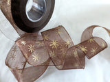 Berisfords Ribbons Dark brown super sheer ribbon with a metallic gold Christmas star print. 27mm wide. Buy online per metre & cut to length with full roll discounts.