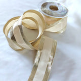 Cream polyester taffeta ribbon with metallic gold borders and wire edged. 40mm wide, made in the UK by Berisfords Ribbon. buy by the metre and cut to length.