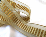 Gold mesh ribbon with a metallic lurex and old gold brown banded centre. 40mm wide, double face and wire edge. Buy online per metre Ribbonmoon ribbons UK online shop.