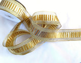 Gold mesh ribbon with a metallic lurex and old gold brown banded centre. 40mm wide, double face and wire edge. Buy online per metre Ribbonmoon ribbons UK online shop.